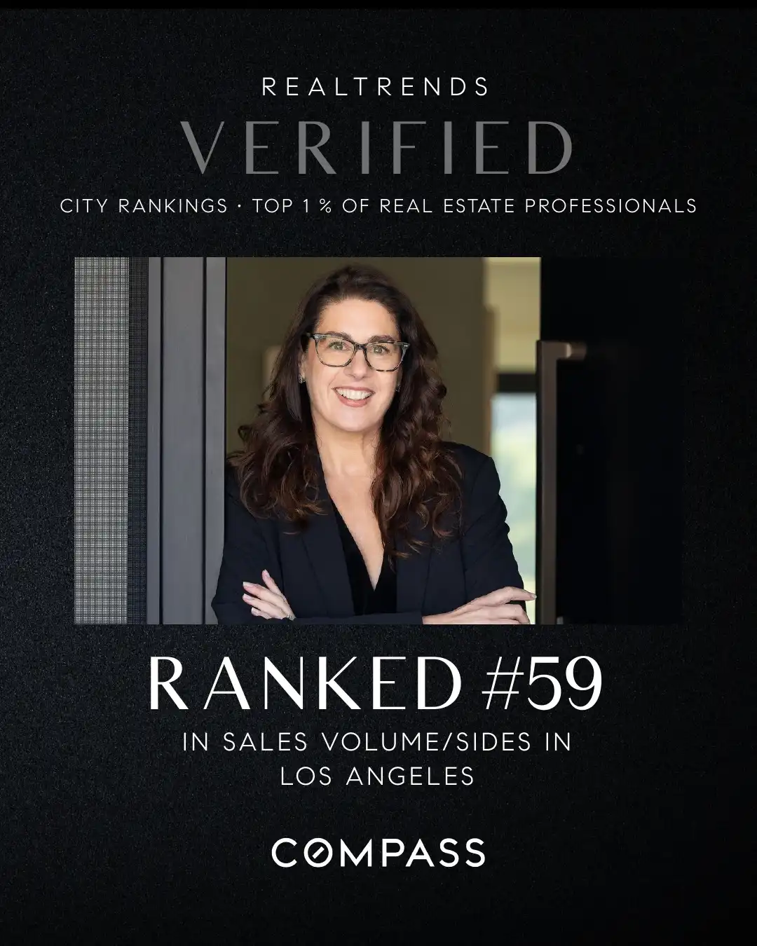 A digital promotional graphic with a black textured background. Silver text at the top reads 'REALTRENDS VERIFIED CITY RANKINGS - TOP 1 % OF REAL ESTATE PROFESSIONALS'. The center features a portrait photograph of a female real estate agent with dark hair and glasses, wearing a dark blazer and standing in a doorway with her arms crossed. Below the portrait, white text reads 'RANKED #59 IN SALES VOLUME/SIDES IN LOS ANGELES', followed by the Compass real estate brokerage logo at the bottom.