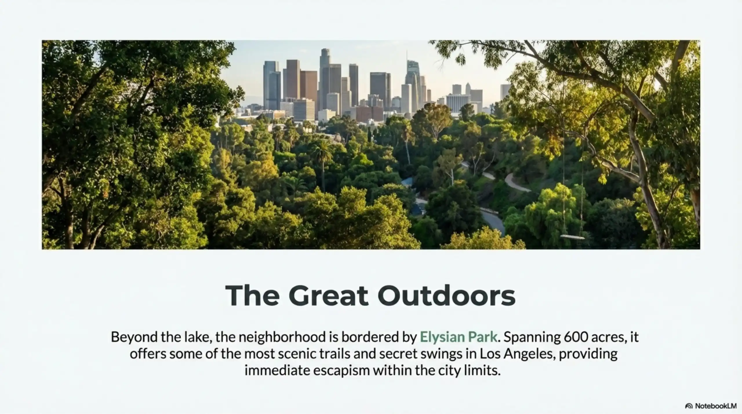 Elevated view of lush green trees in Elysian Park with the Los Angeles skyline in the background.