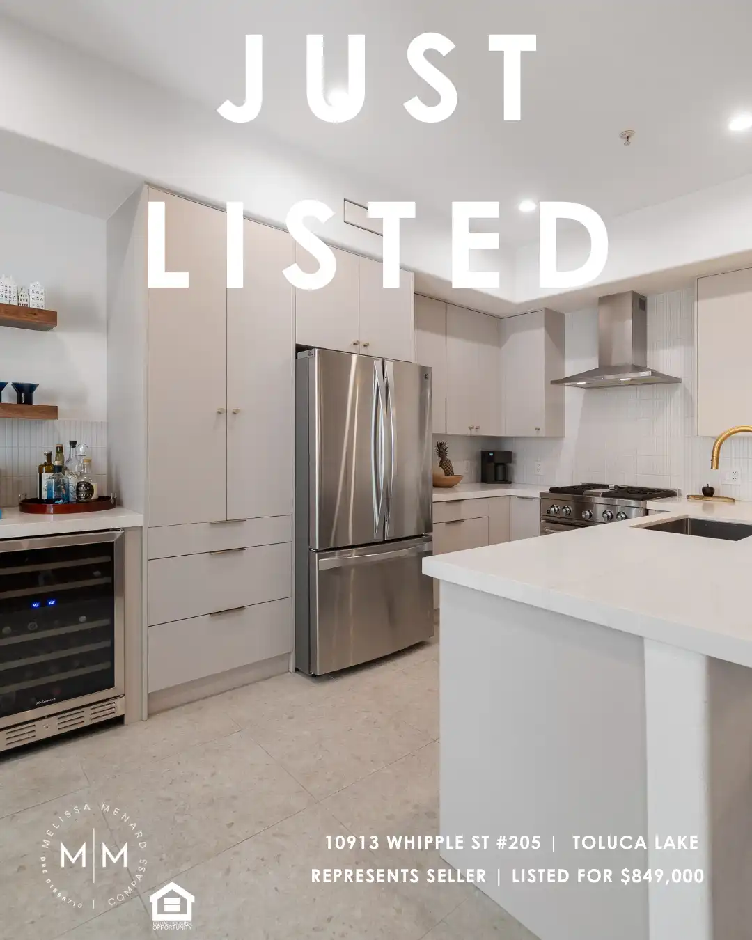 Modern kitchen with stainless steel appliances, flat-panel cabinets, and built-in wine fridge.