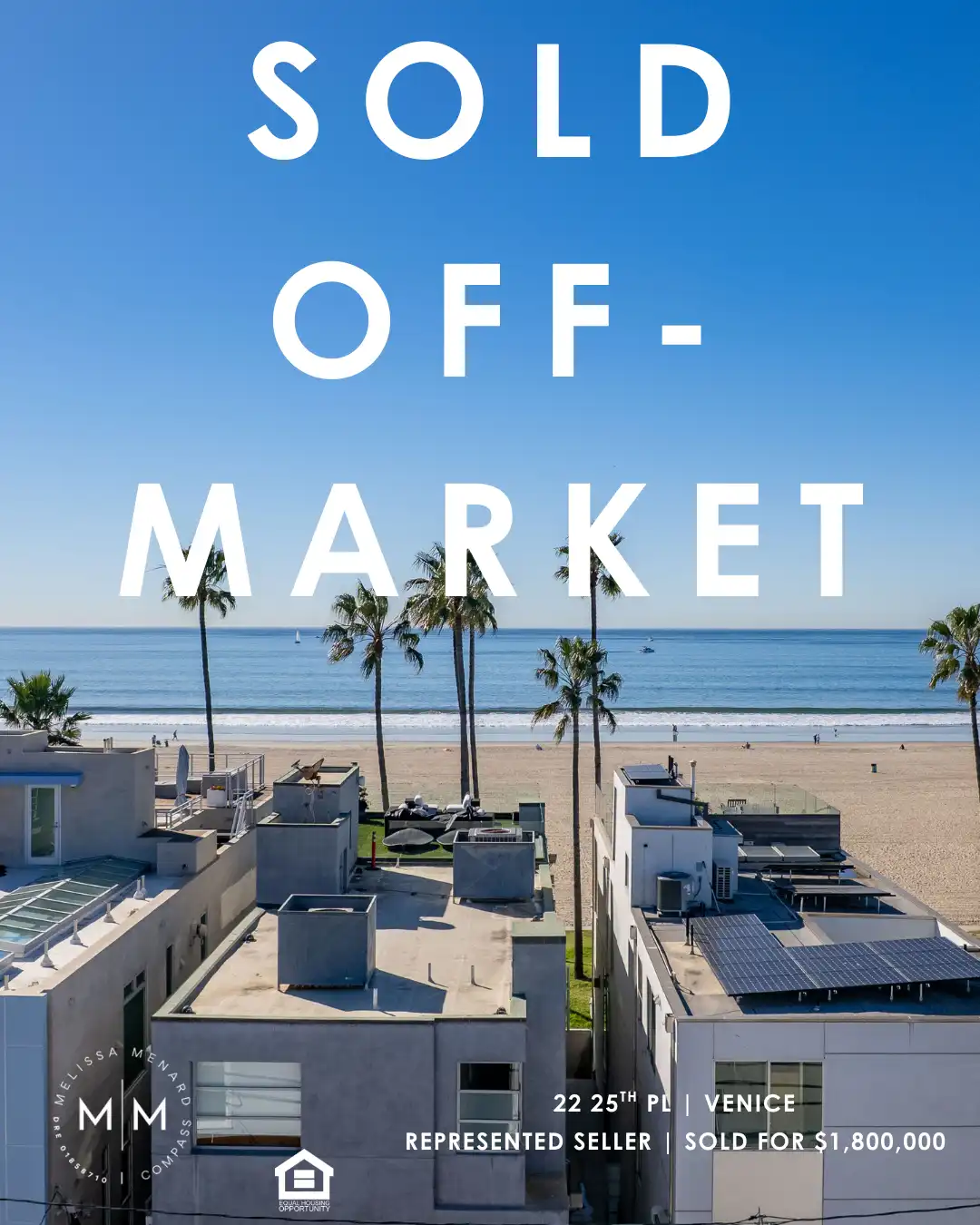 Aerial view of residential rooftops in Venice California with beach and ocean in background.