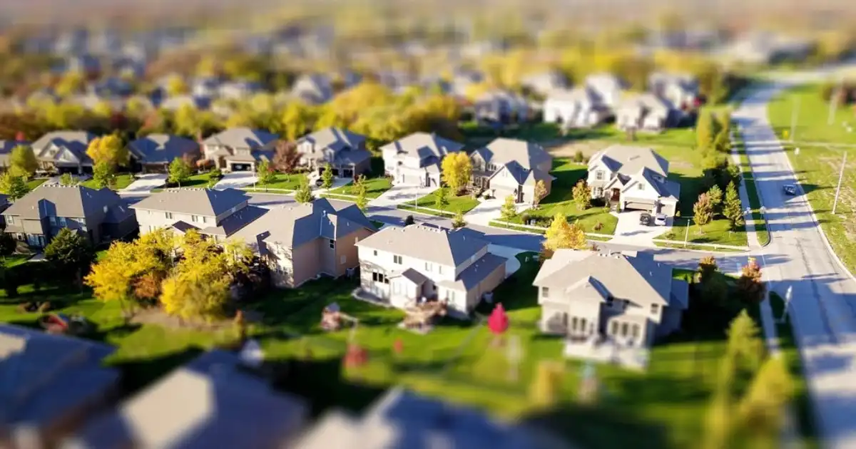 Aerial view of a suburban neighborhood with tree-lined streets