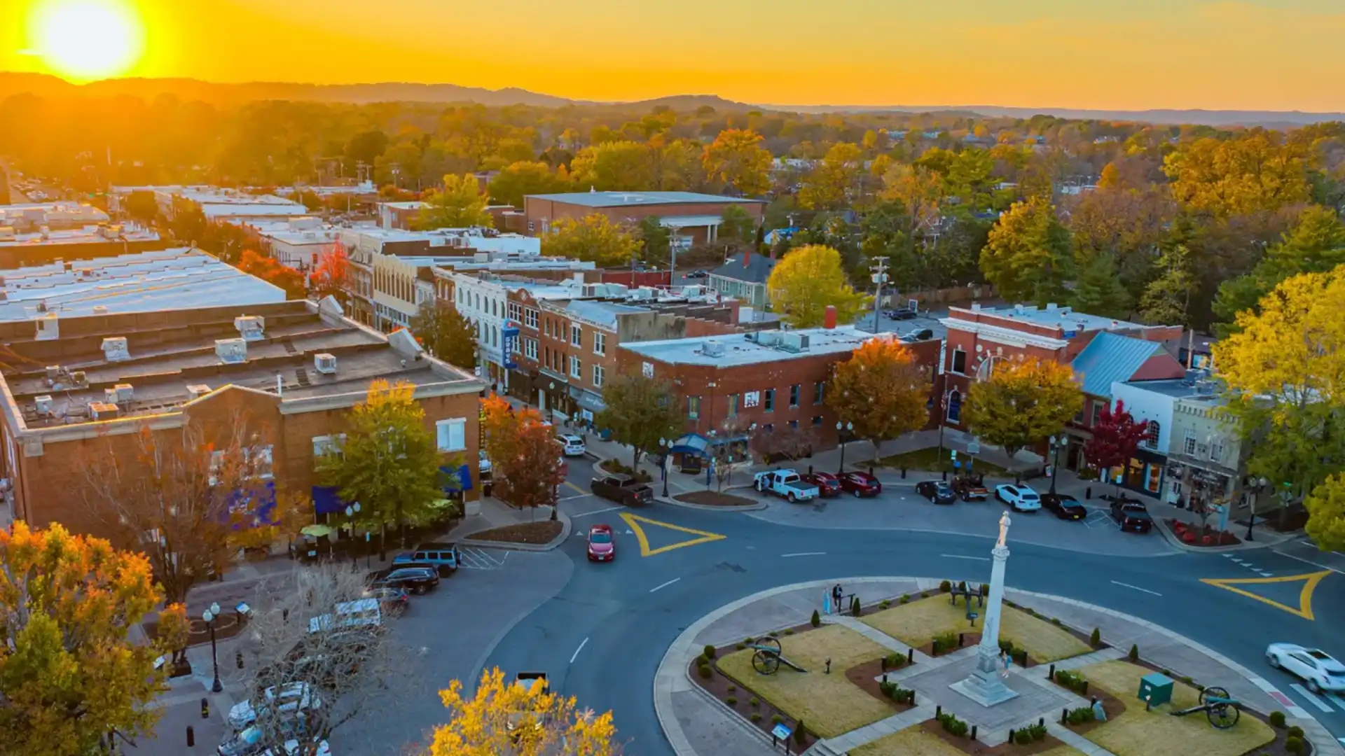 Aerial view of downtown Franklin Tennessee showing historic town square, Main Street buildings, and tree-lined residential neighborhoods at sunset