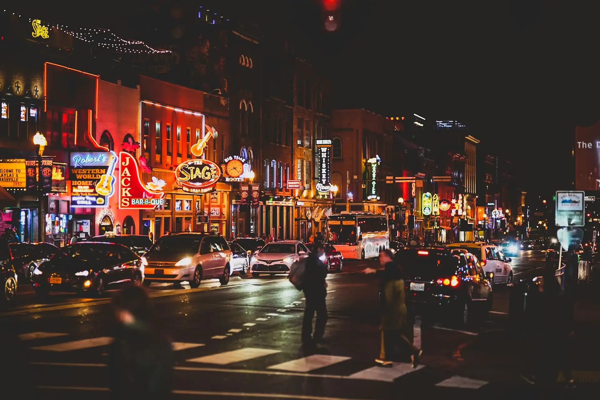 Neon signs and honky-tonks along Lower Broadway in downtown Nashville at night