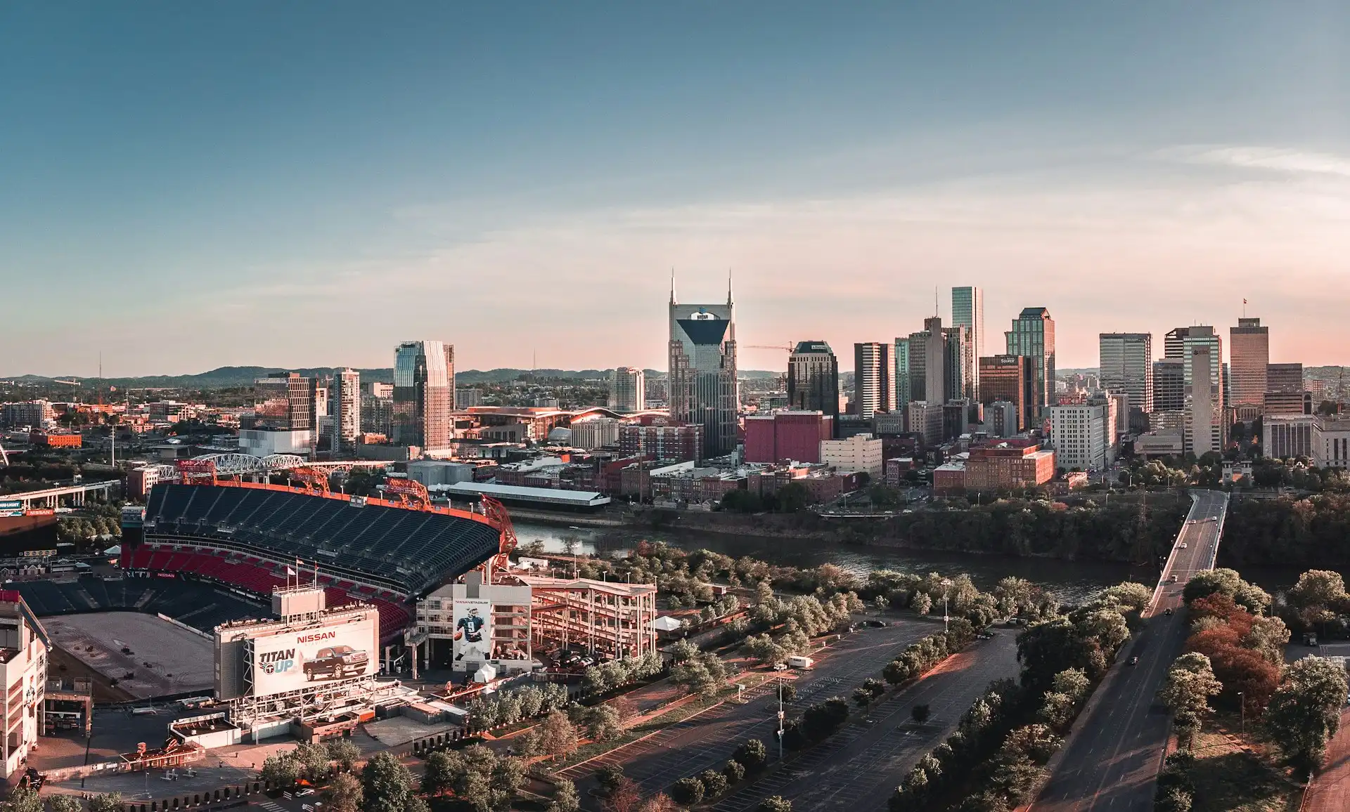 Nissan Stadium beside the Cumberland River with the downtown Nashville skyline behind it