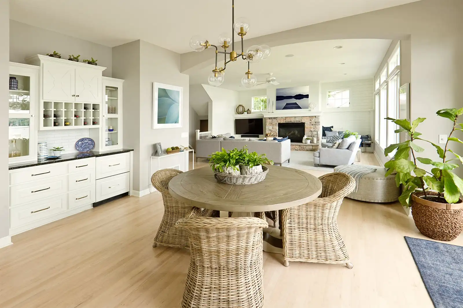 Bright dining area with a round table, chairs and an adjoining kitchen