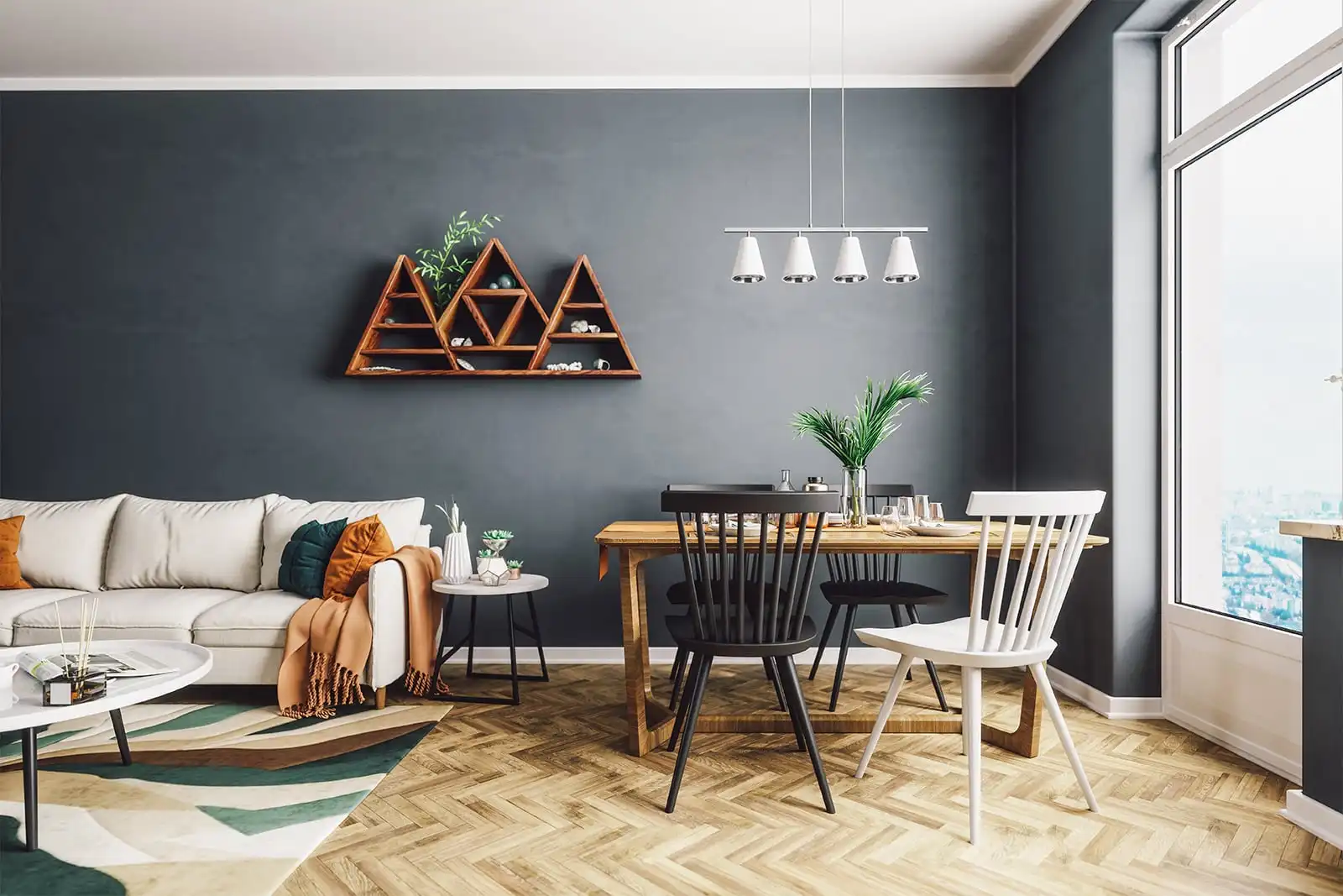 Living and dining area with a sofa, dining table, pendant lights and geometric shelves