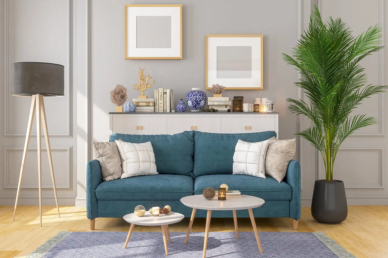 Living room with a sofa, teal cushions, framed artwork and a tall plant