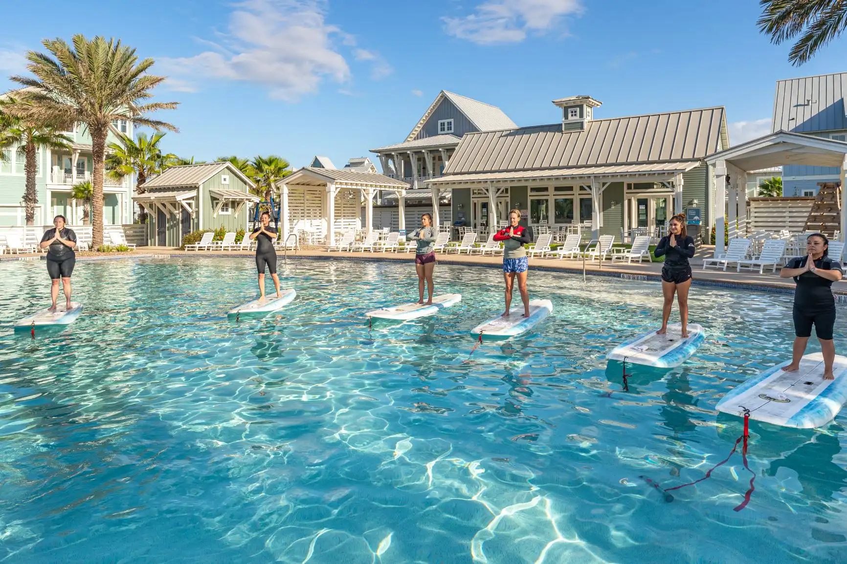group doing paddleboard yoga at cinnamon shore