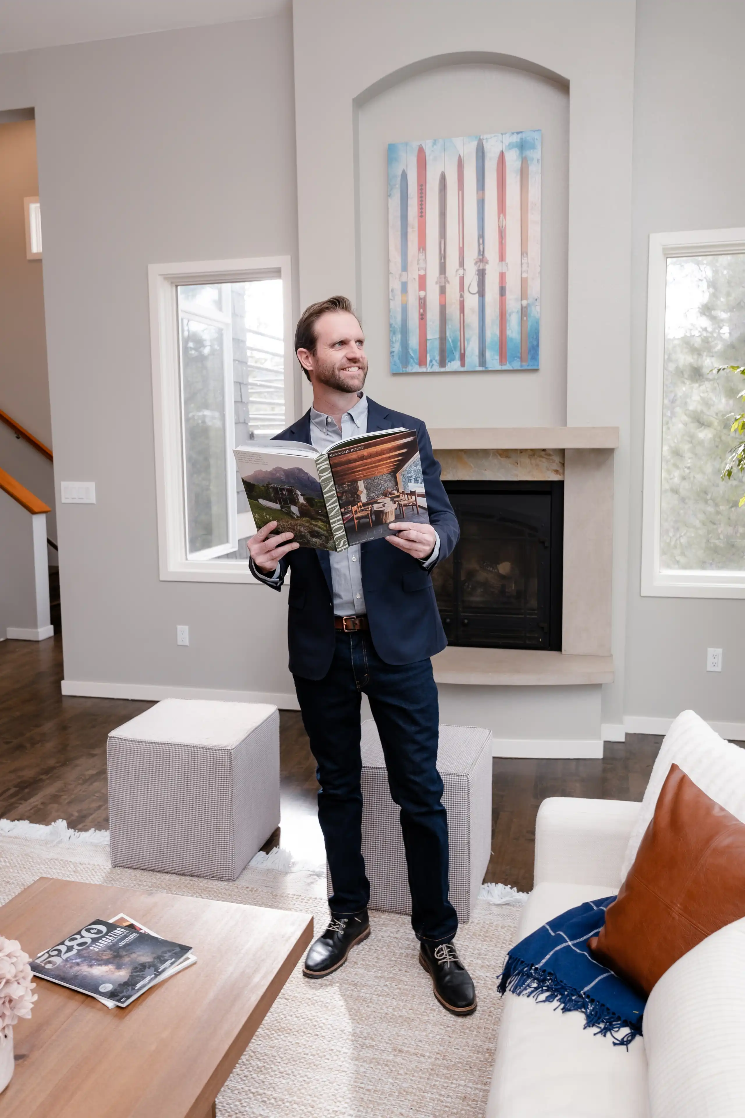 Tucker Volk, Colorado Realtor, holding a book in home